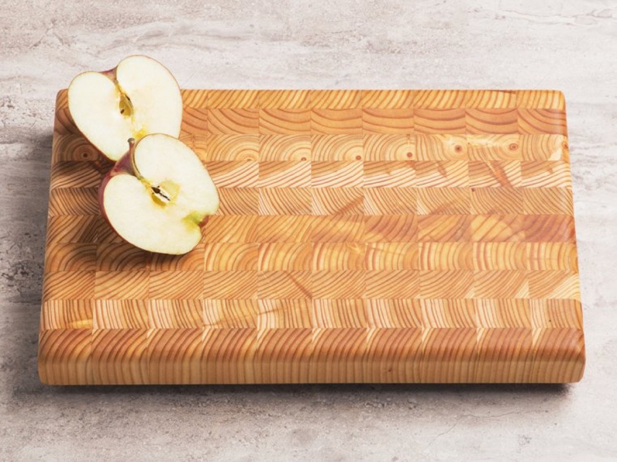 bisected apple on wood cutting board, kitchen decorations