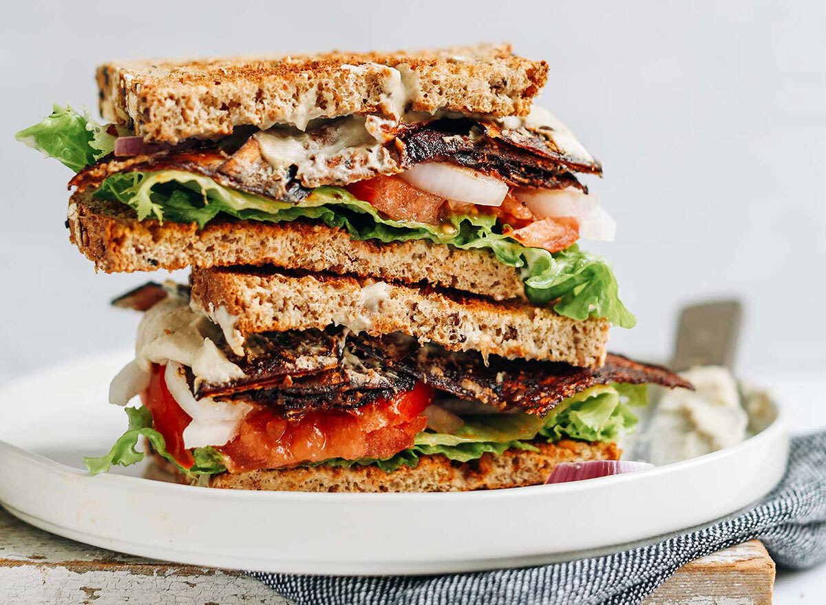 vegan blt sandwich halves stacked on serving platter