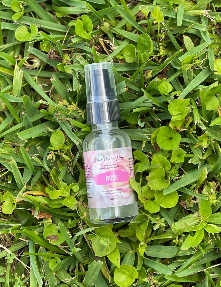 bottle of hand sanitizer in grass