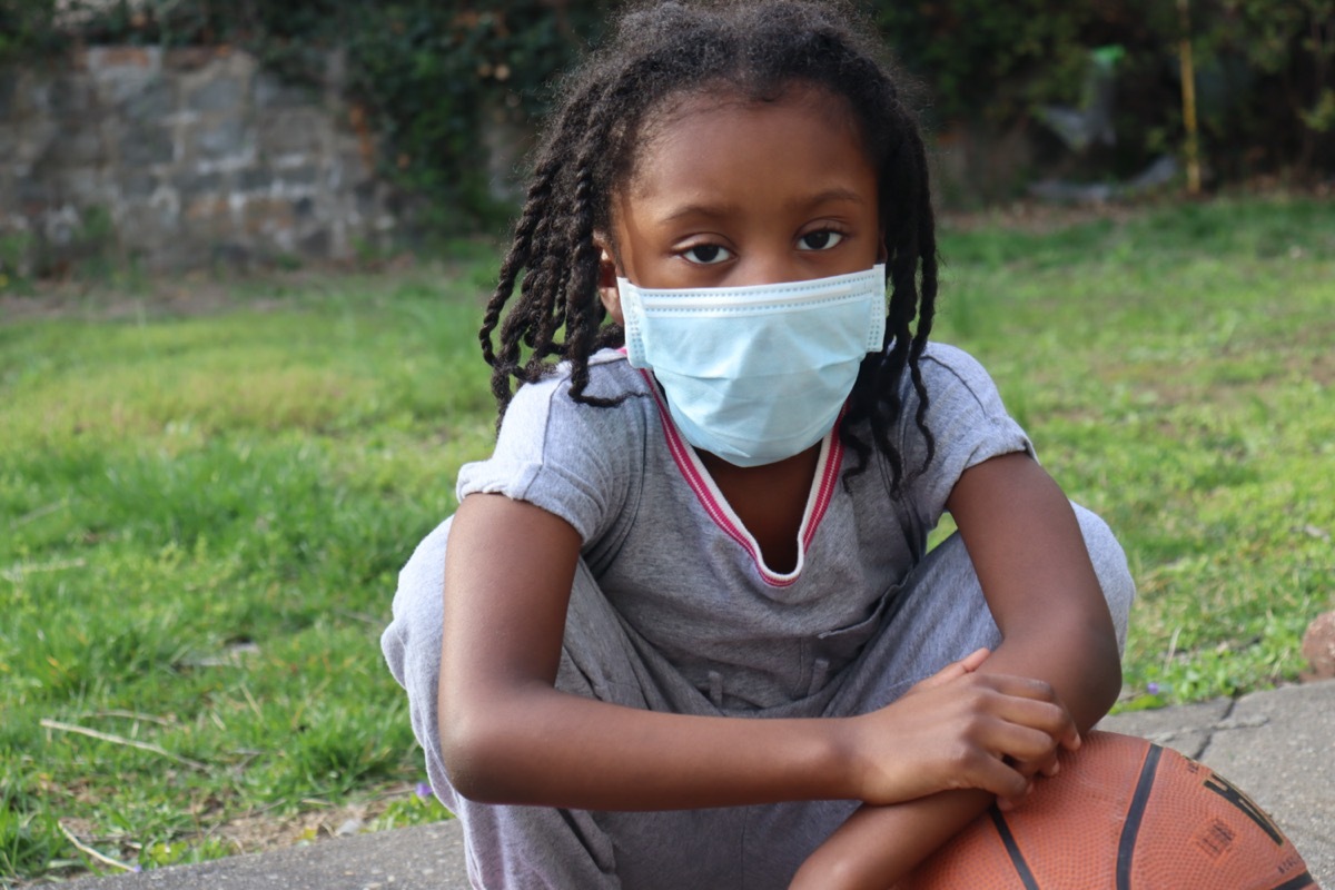 African American Kid wearing surgical mask with basketball