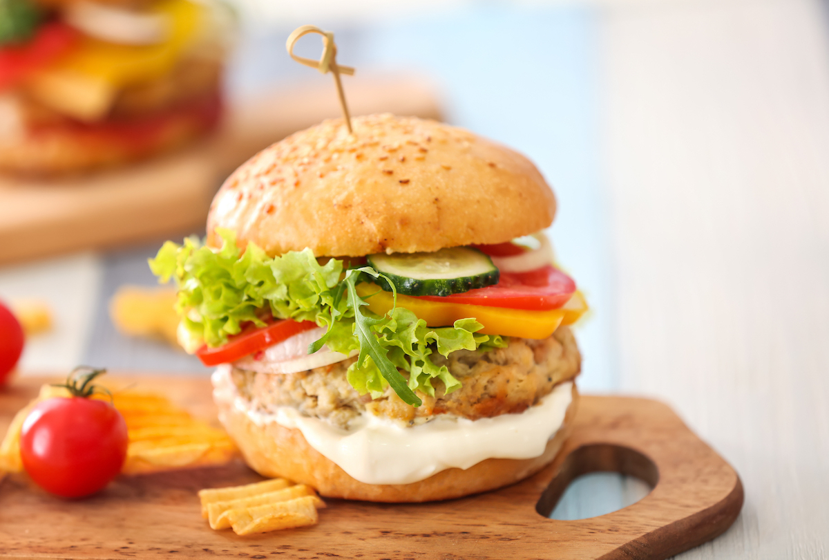 turkey burger with veggies on wooden board