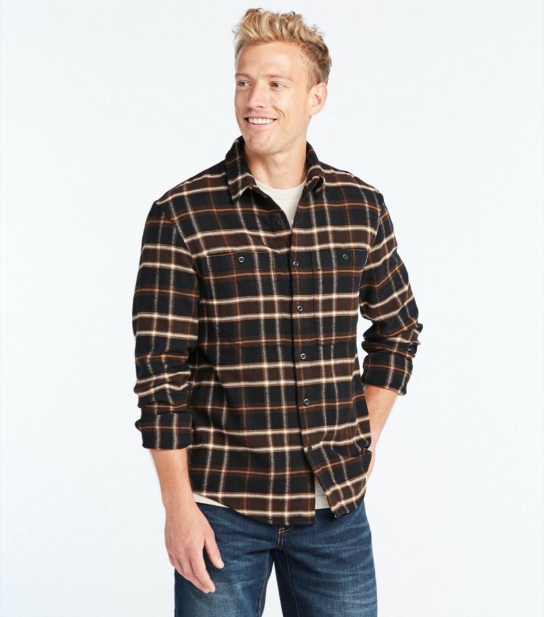 young man in brown and black plaid shirt and jeans