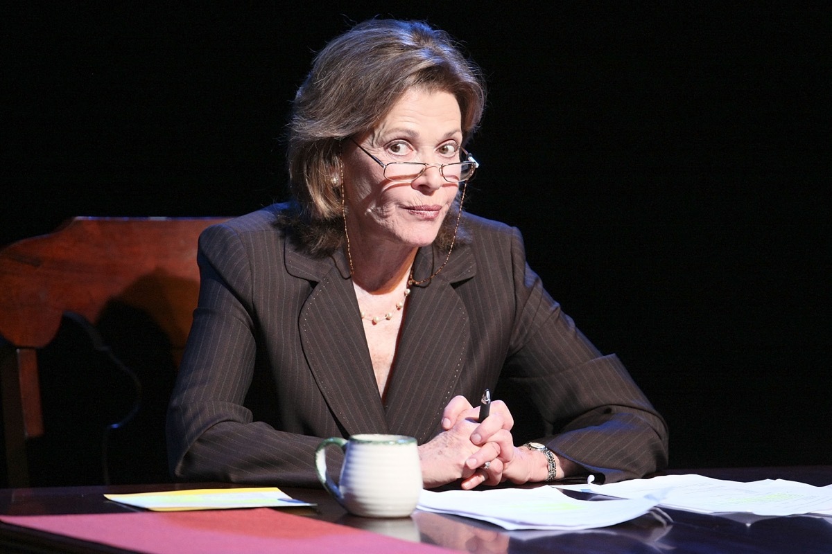 jessica walter wearing glasses sitting at a desk