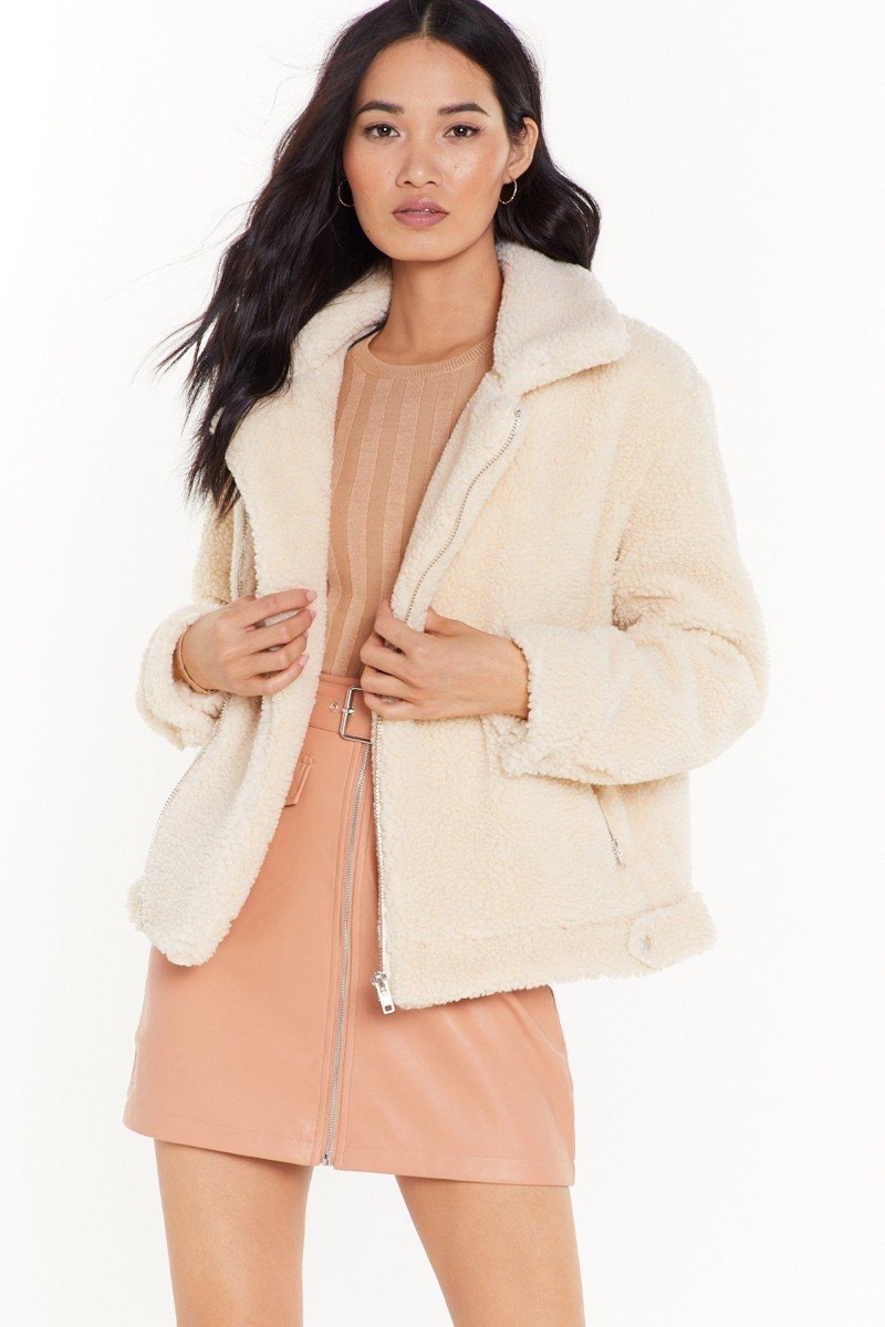 woman in off-white faux fur jacket, end of summer sales 2019