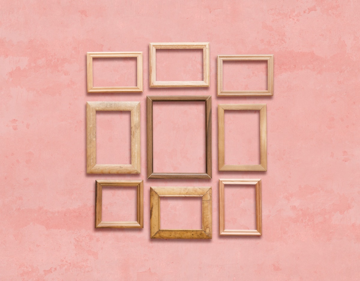 Mismatched photo frames on a pink wall vintage home trends