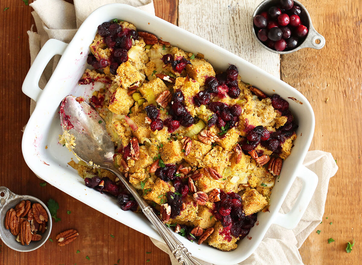 vegan cornbread stuffing with cranberries and pecans in white serving dish