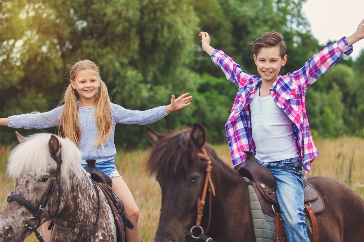 Kids riding horses excited