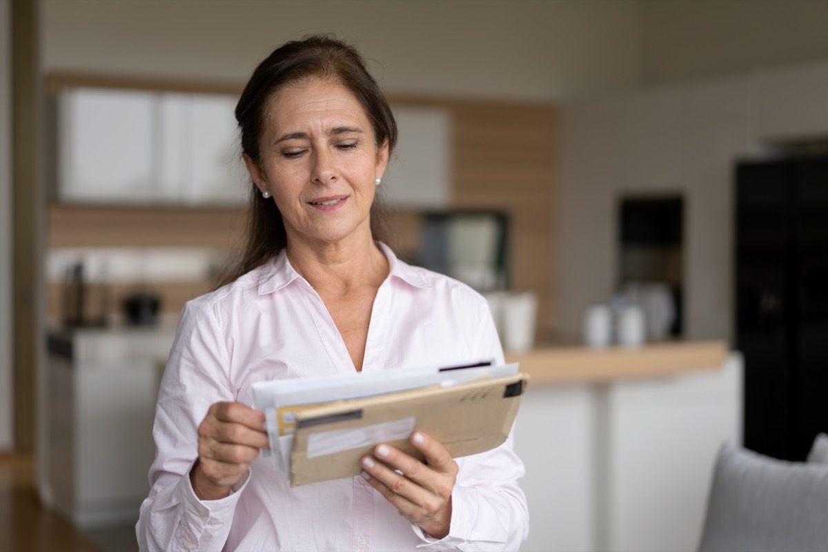 woman at home checking her mail - Lifestyles