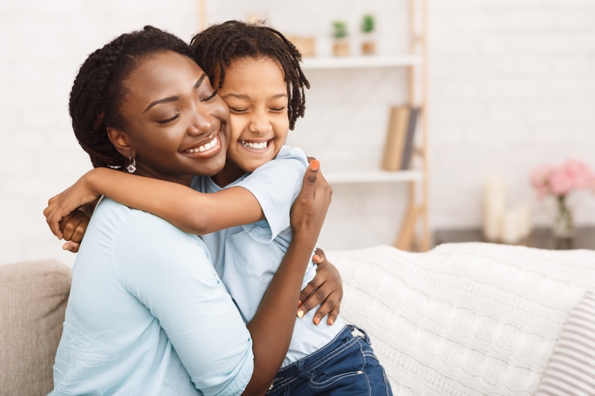 Mother hugging smiling child