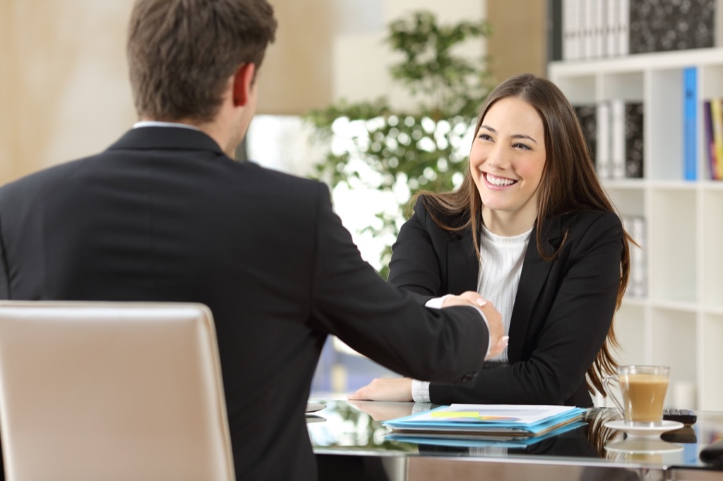 A businessman interviewing a woman for a job ways to get a promotion after 40