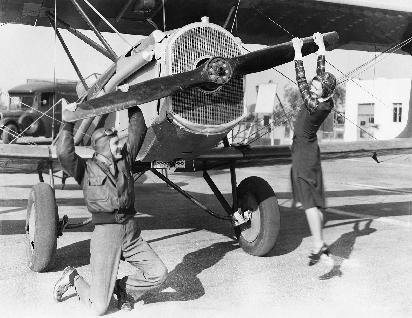 a man and a woman play with a plane propeller