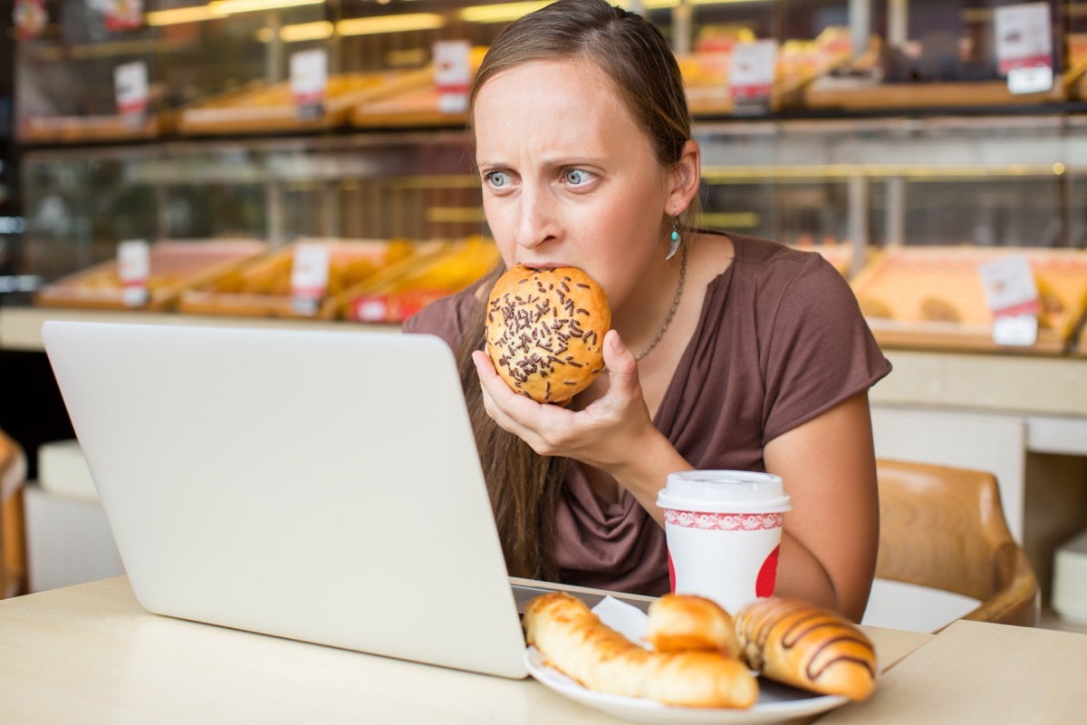 woman stress eating a piece of bread, stress signs