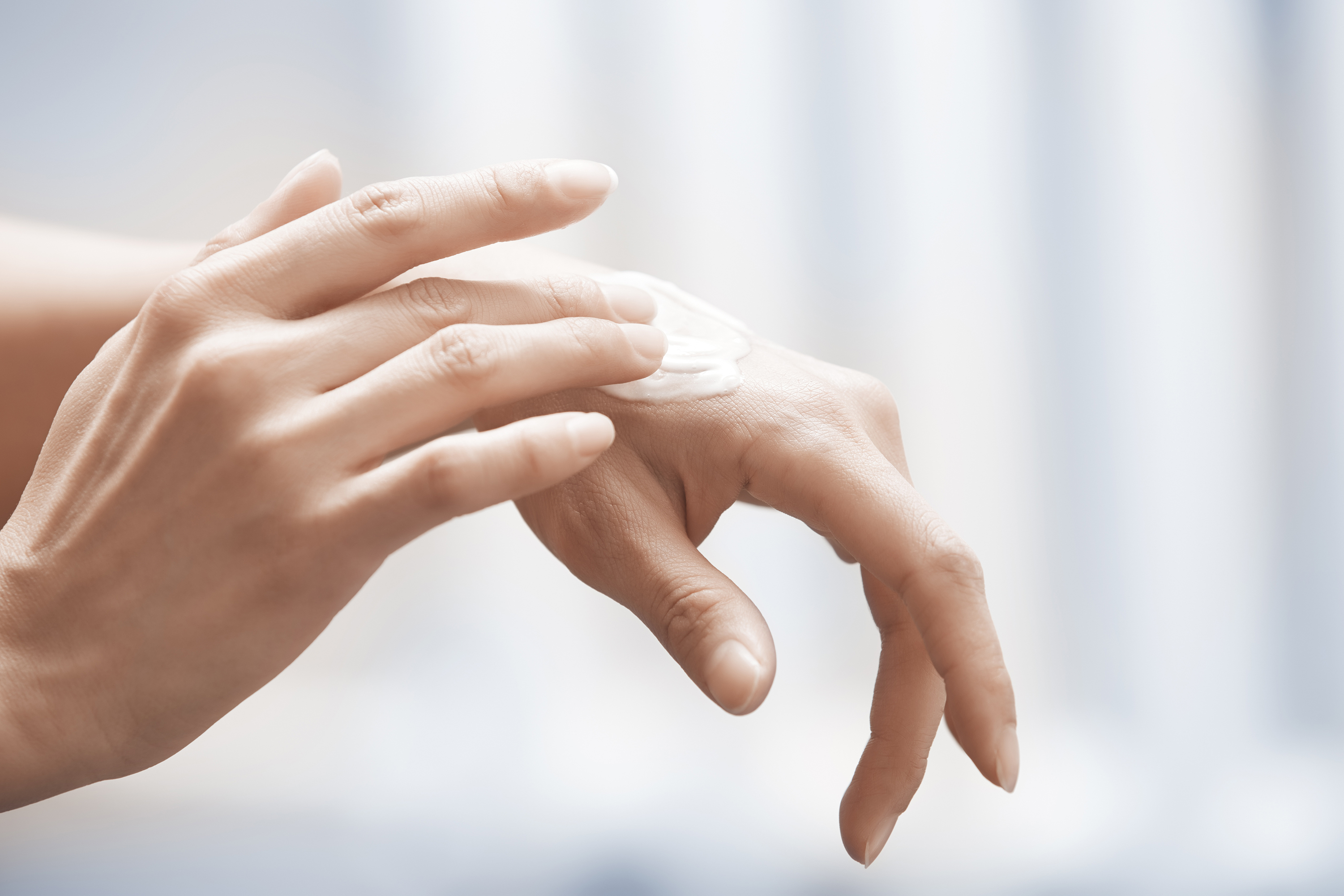 applying hand cream, healthy skin in your 40s