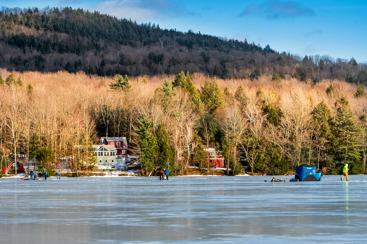 Ice fishers setup traps and drill holes in the ice on Lake Iroquois in Hinesburg, Vermont
