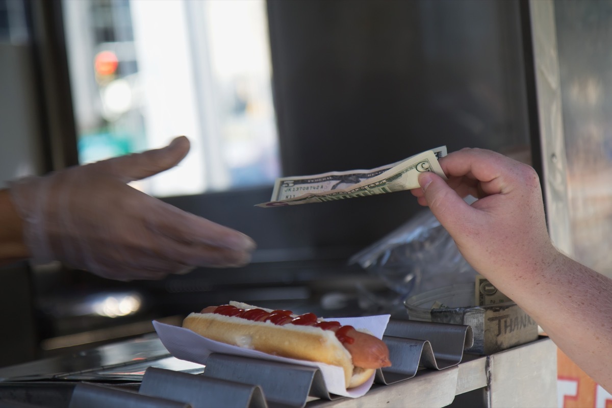 paying for hot dog at stand