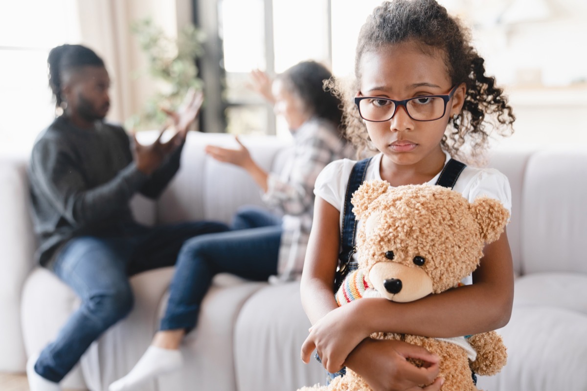 Sad stressed little preteen girl feeling scared while her parents divorce, arguing, having marriage problems. Misunderstaning between partners. Psychology therapy.