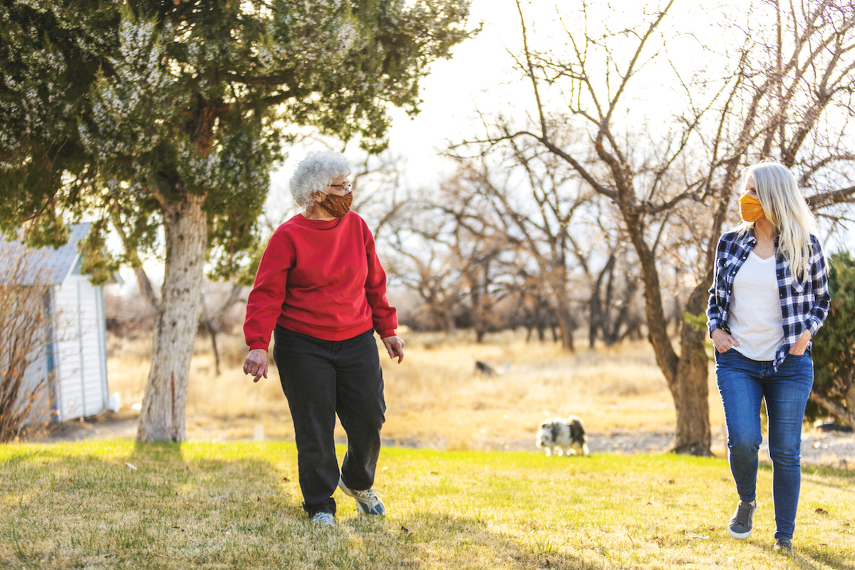 In Western Colorado Mature Adult Female and elderly senior adult female Wearing Face Masks and Demonstrating Social Distancing Due to Infectious Virus