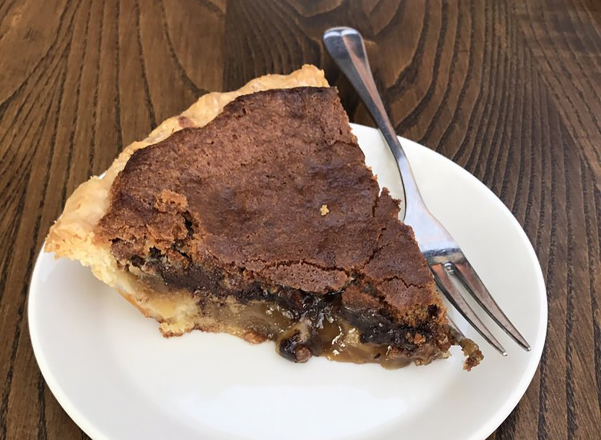 chocolate pecan pie slice on white plate