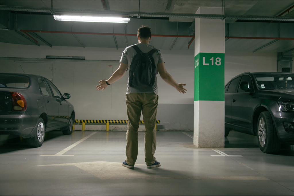 Man looking at parking spot where his car used to be