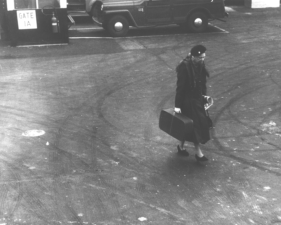 Eleanor Roosevelt walks on a tarmac
