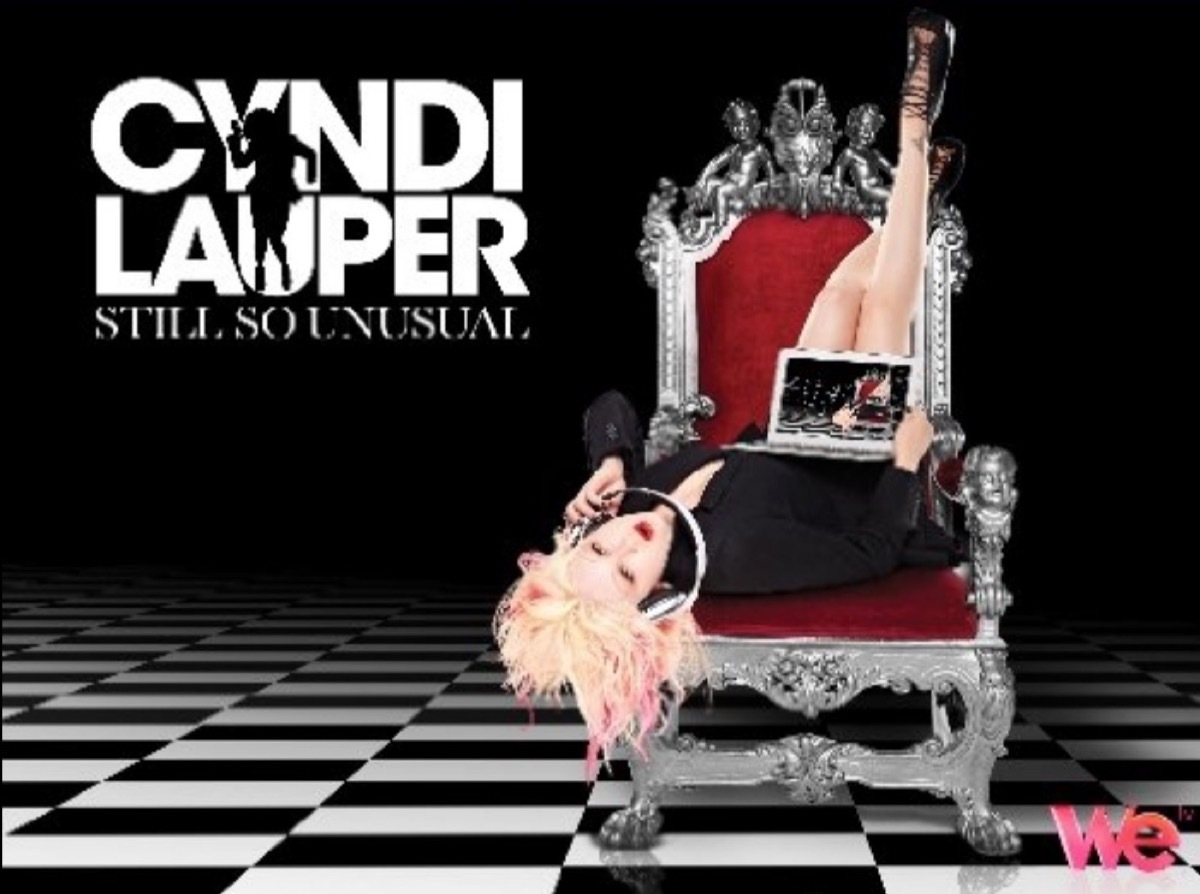cyndi lauper sitting upside down in a throne with the words 