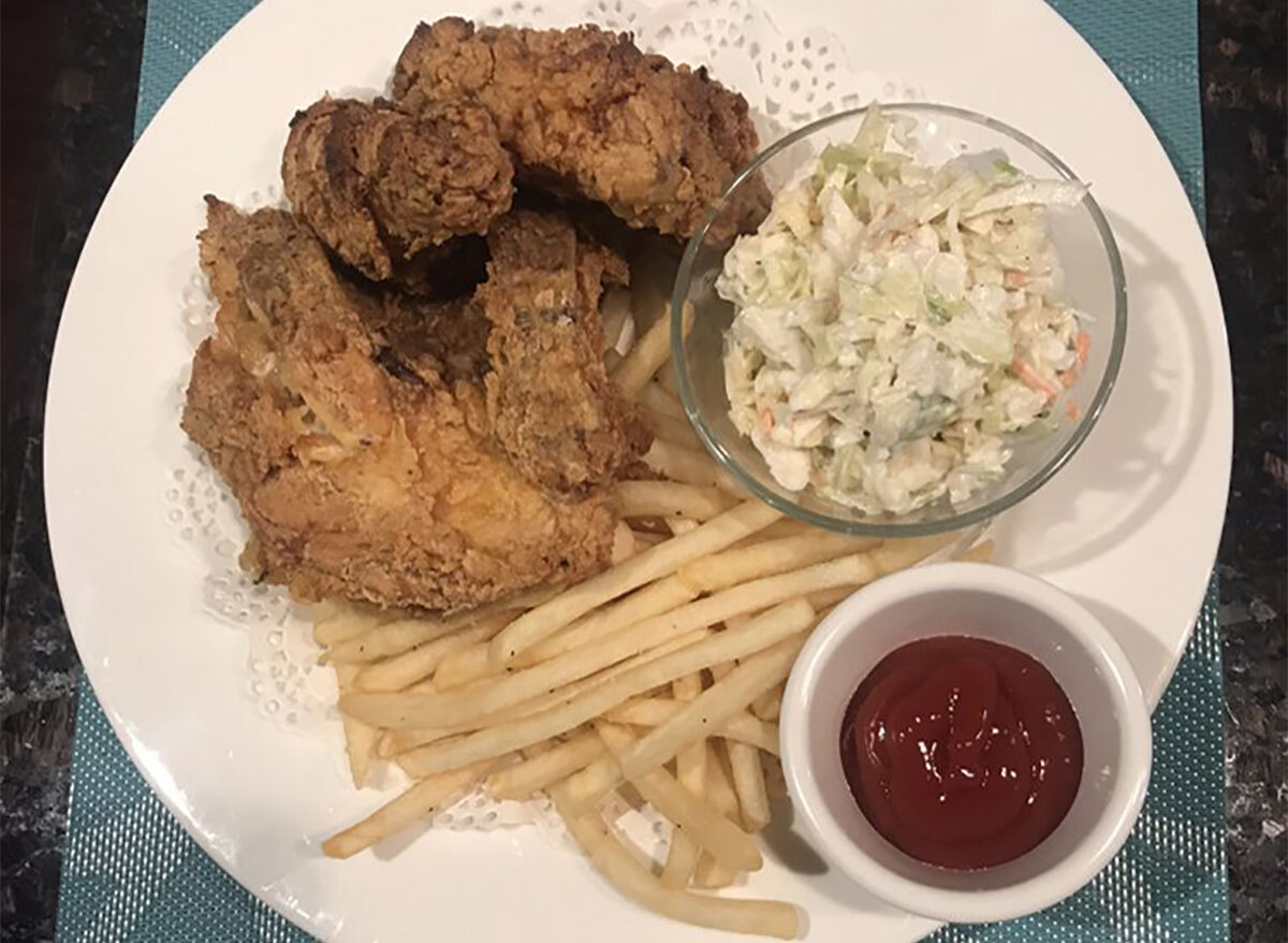 plate of fried chicken with fries coleslaw and ketchup