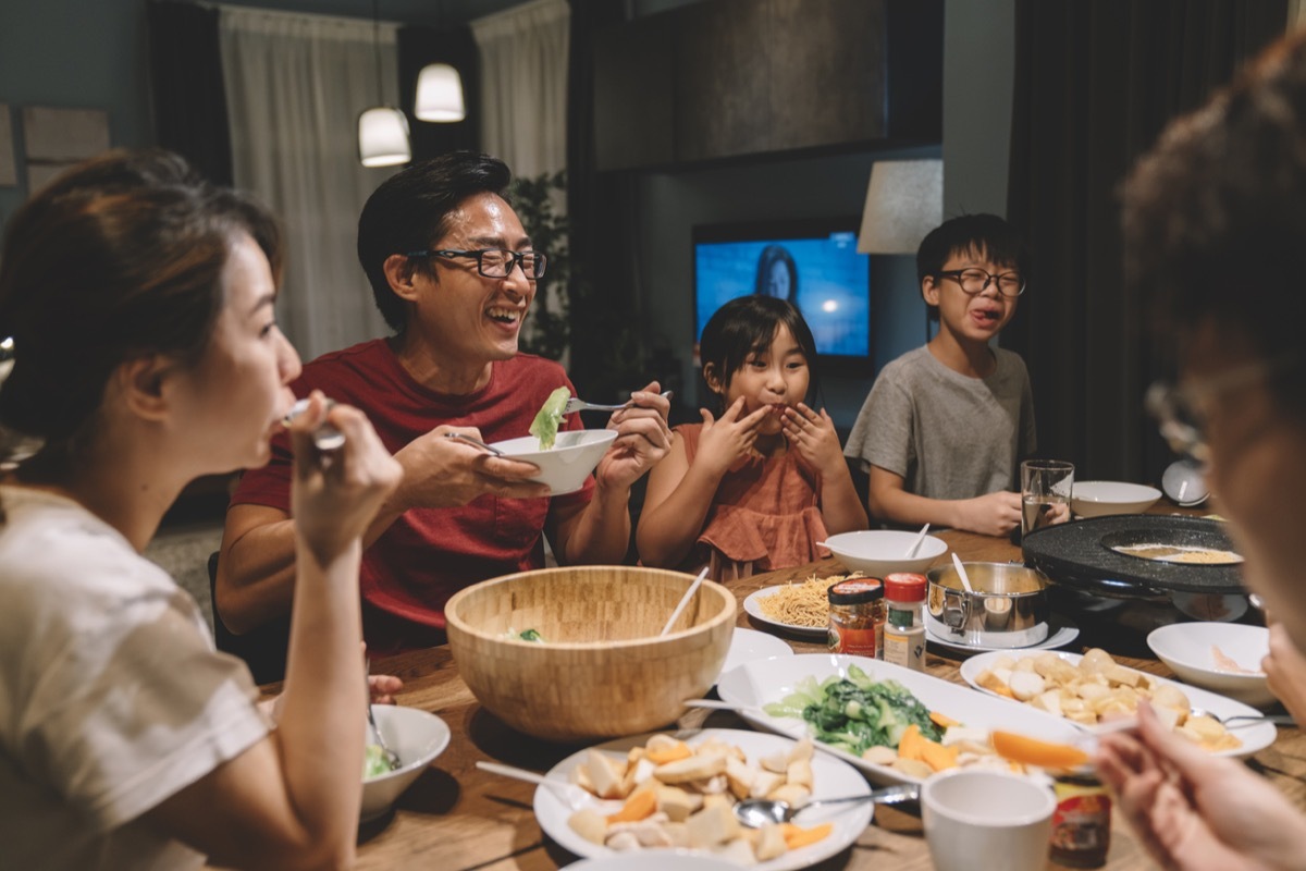 family laughing at dinner table