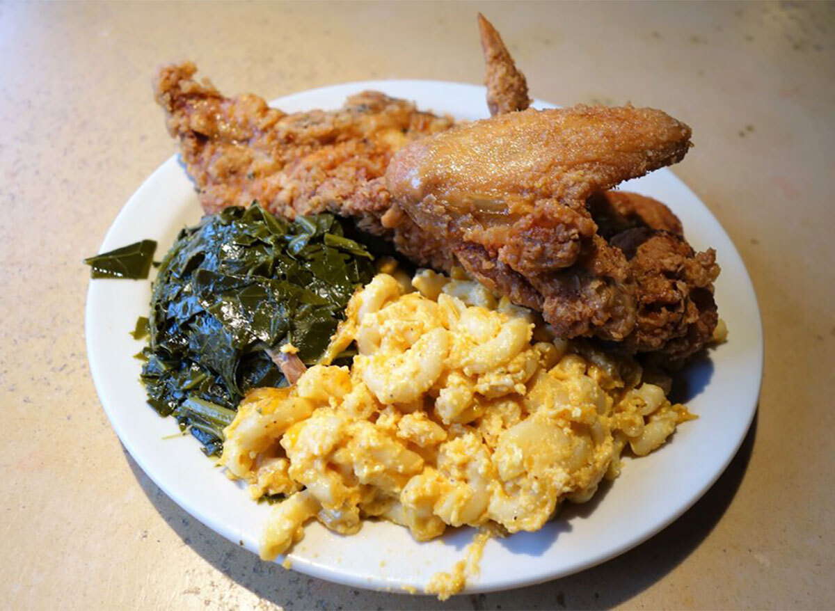 plate of fried chicken with mac and cheese and collard greens