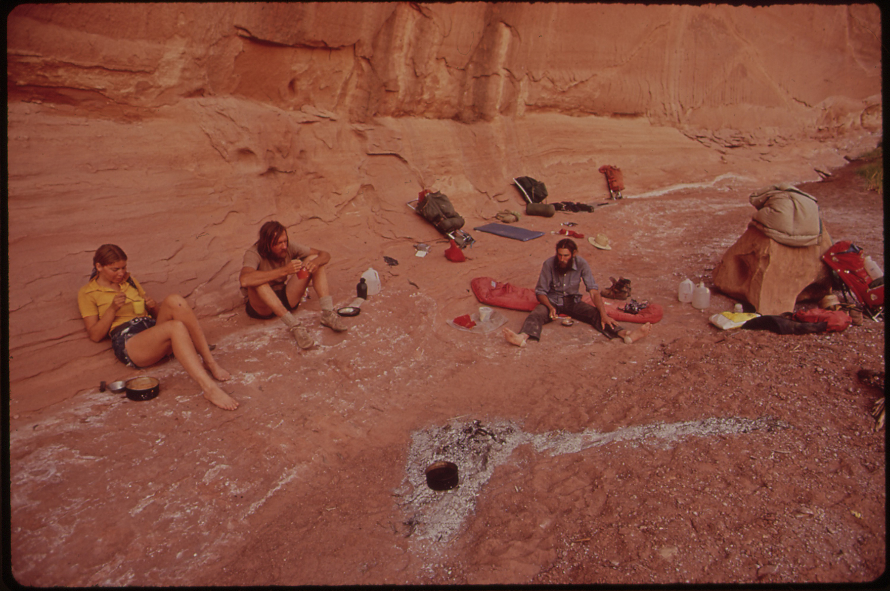 a group of campers sit in a canyon