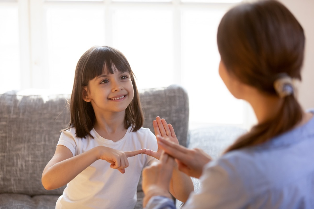 Mother and daughter learning sign language together