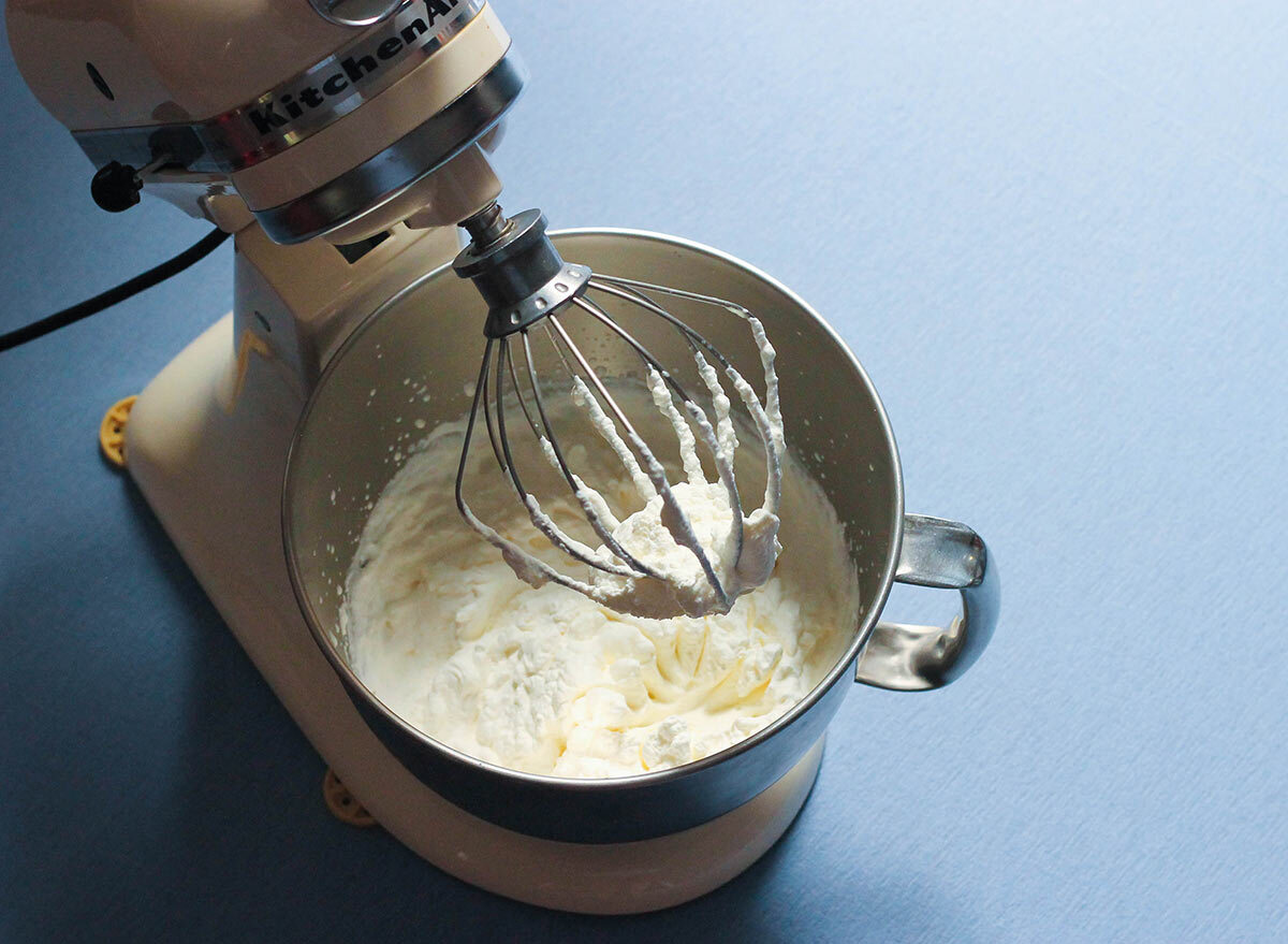 Prepared whipped cream in a stand mixer.