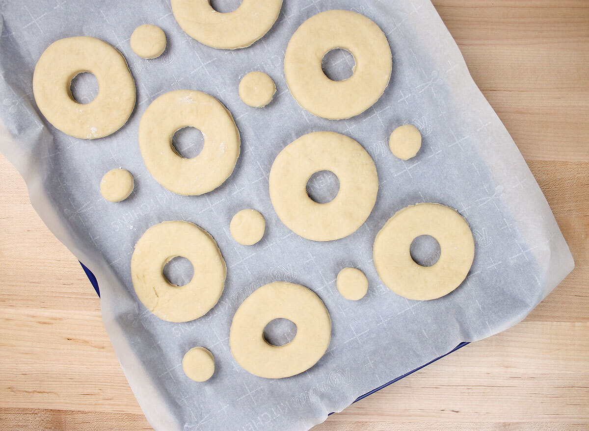 leaving the donut shapes to rise on a sheet pan