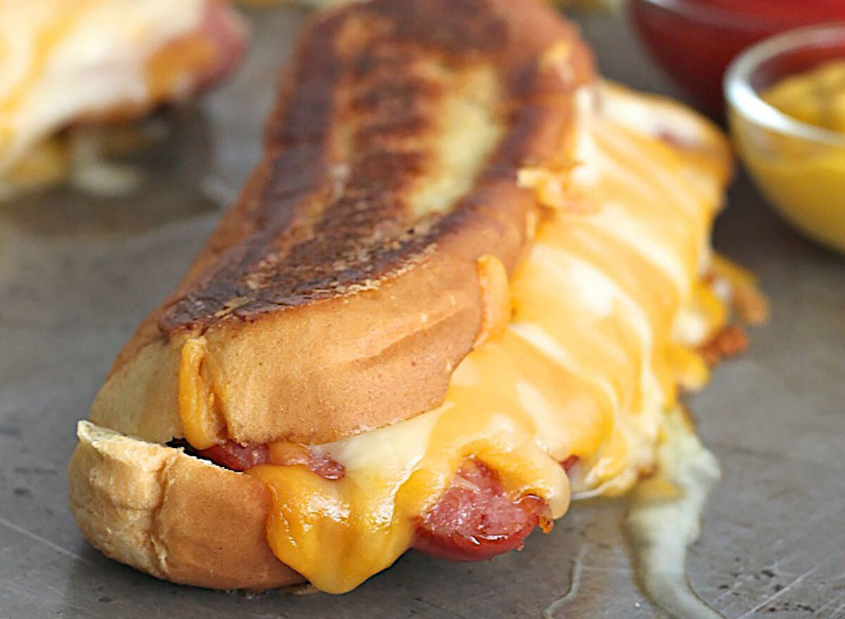 hot dog on grilled cheese sandwich on metal background