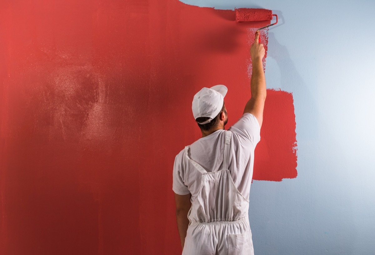 A Male Painter Painting Walls Red Worst Paint Colors