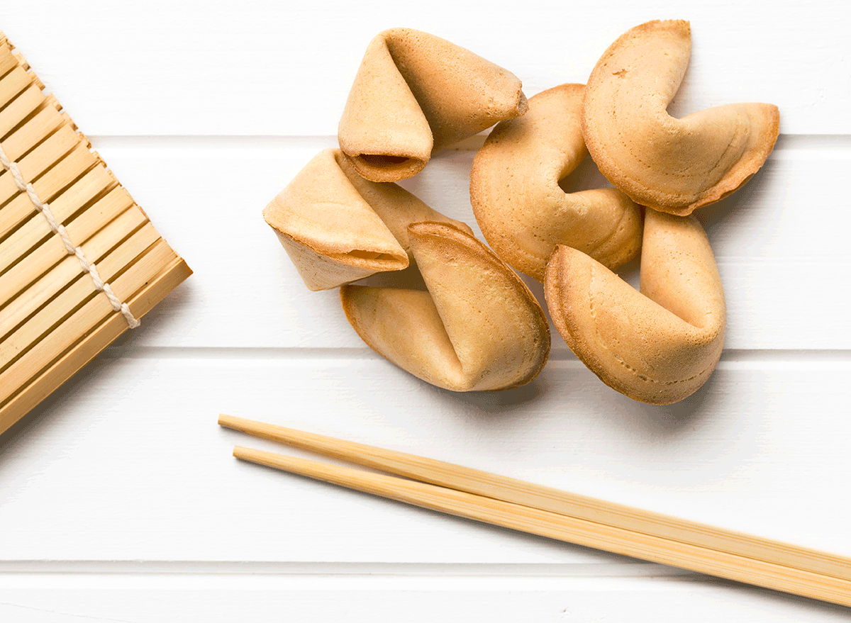 fortune cookies next to bamboo chopsticks and place mat