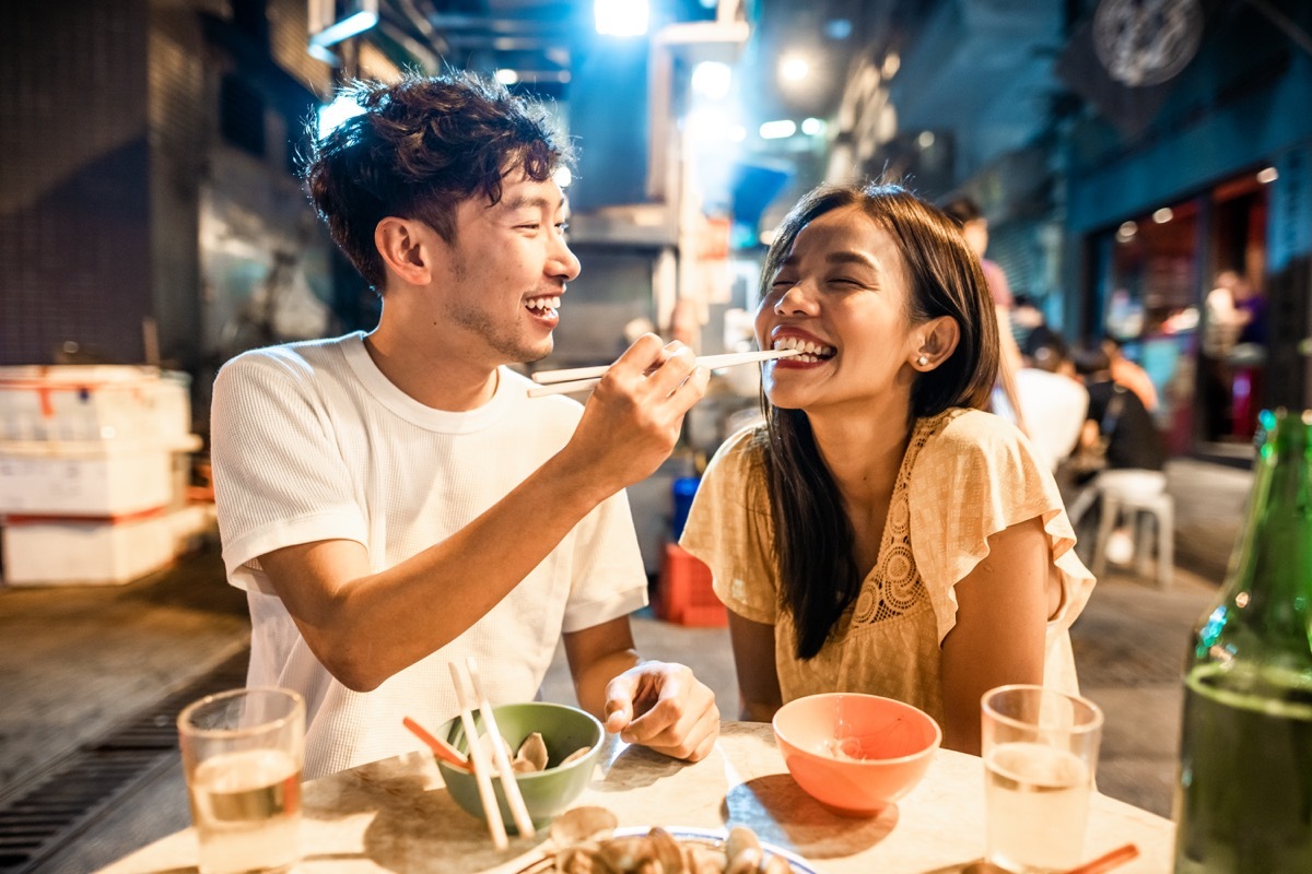 couple enjoying street food in Hong Kong