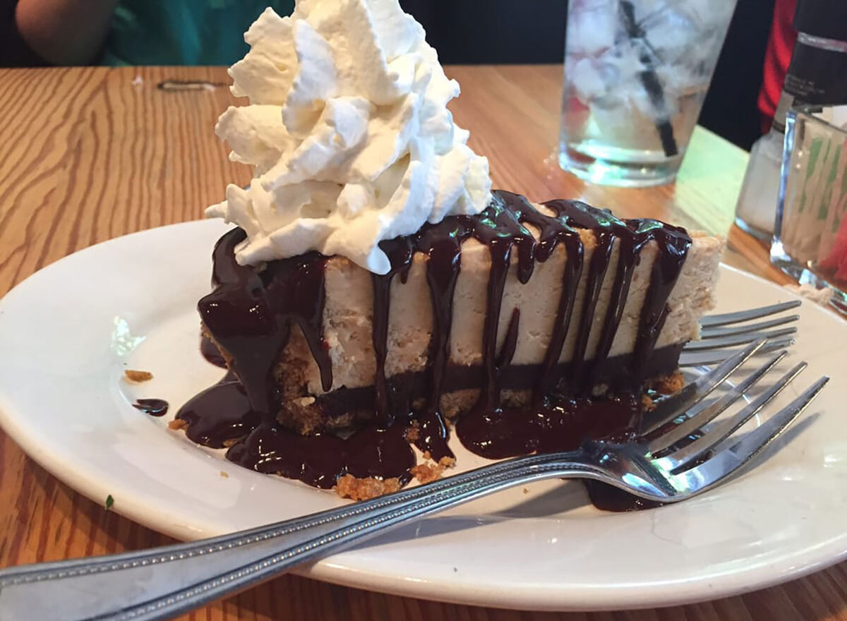 slice of peanut butter pie with fudge and whipped cream