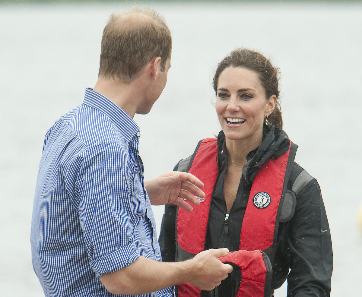 Prince William and his wife Kate, the Duke and Duchess of Cambridge, discuss his team beating hers in the dragon boat race across Dalvay Lake near Charlottetown, Prince Edward Island, July 4, 2011