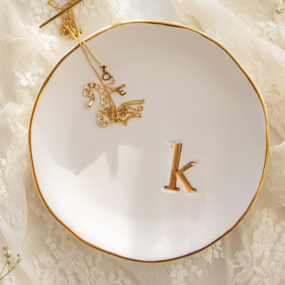 A ceramic jewelry tray with a K painted on it