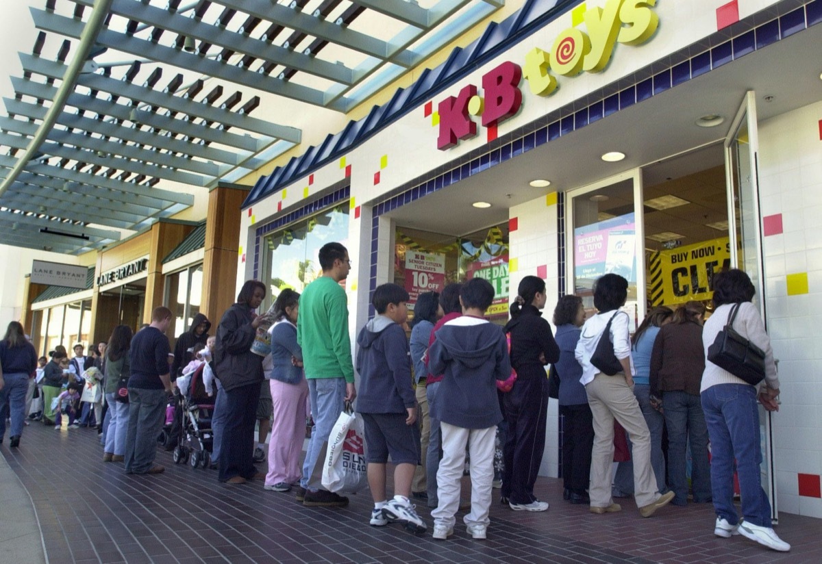 long line of people outside a K.B. Toys store