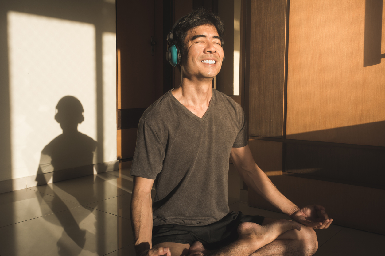 older asian man meditating