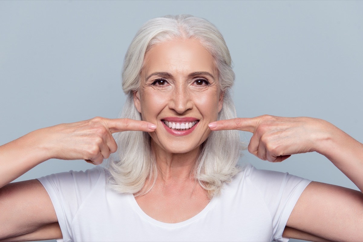 older white woman smiling showing off perfect teeth