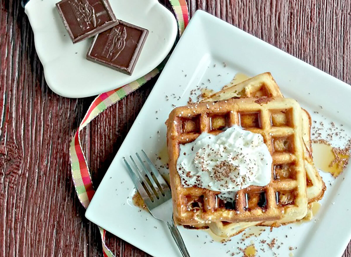 plate of belgian waffles with peanut butter dark chocolate whipped cream