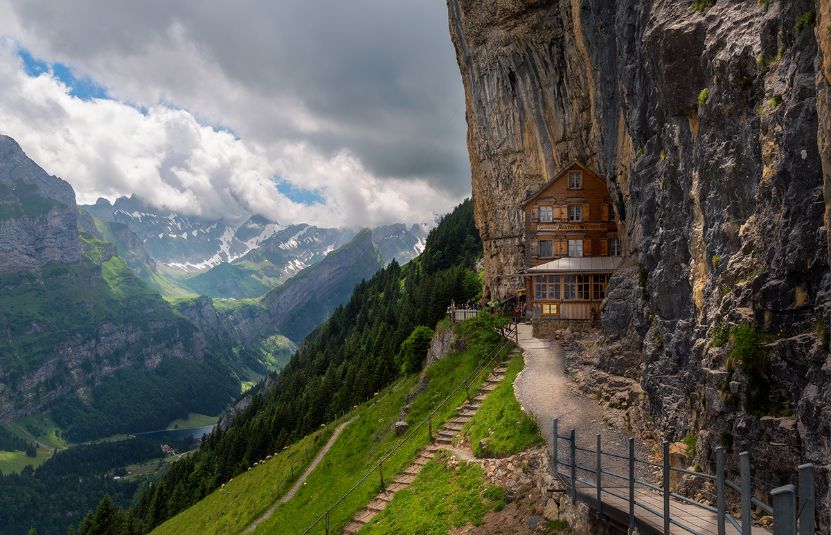 lodge built into the side of a mountain in switzerland