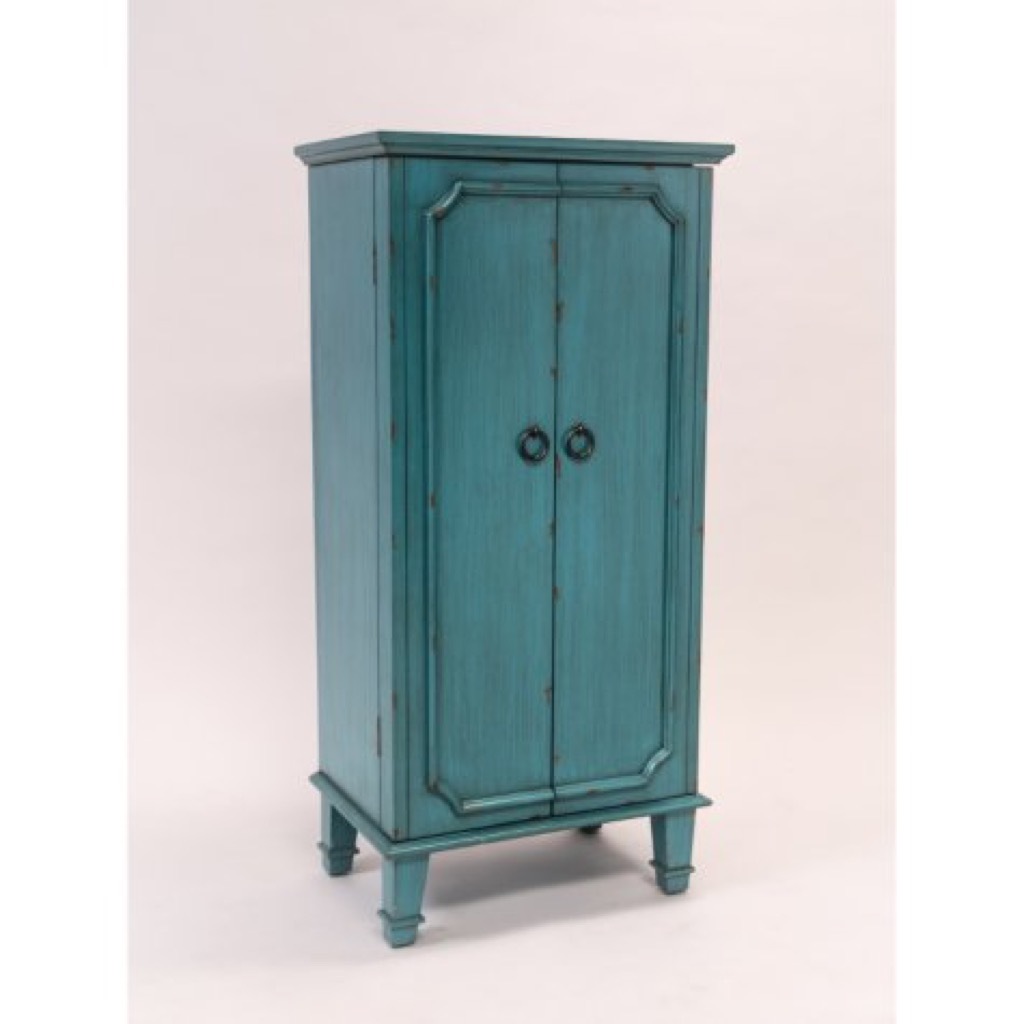A turquoise armoire with jewelry holder