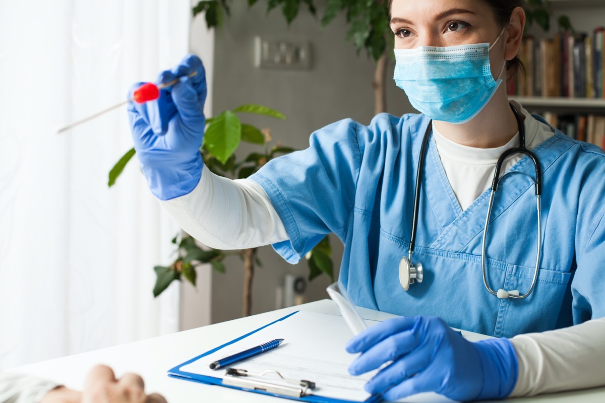 young white female doctor giving coronavirus swab test