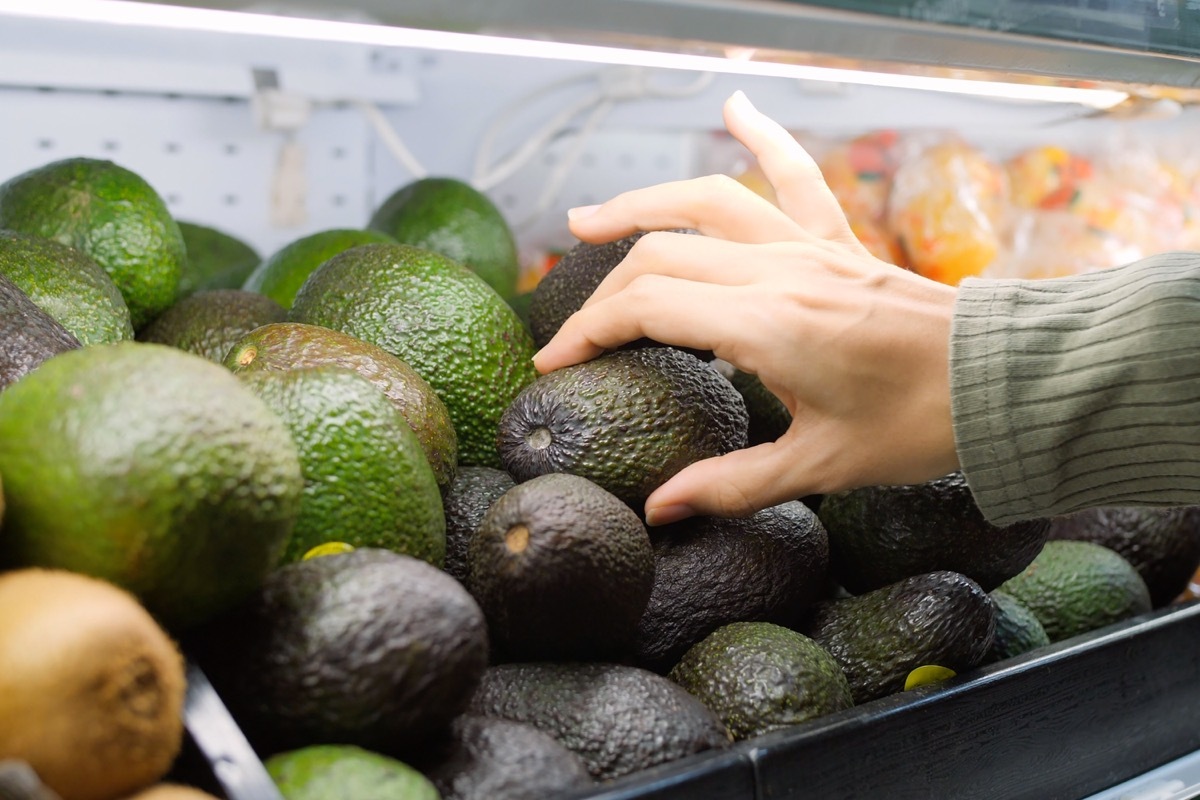Choosing an avocado in store