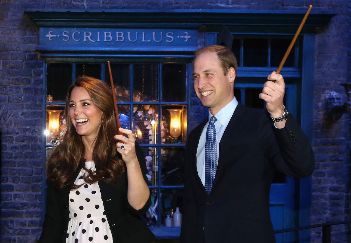 Kate Middleton and Prince William hold wands at the royal visit to Warner Bros Studios in 2013