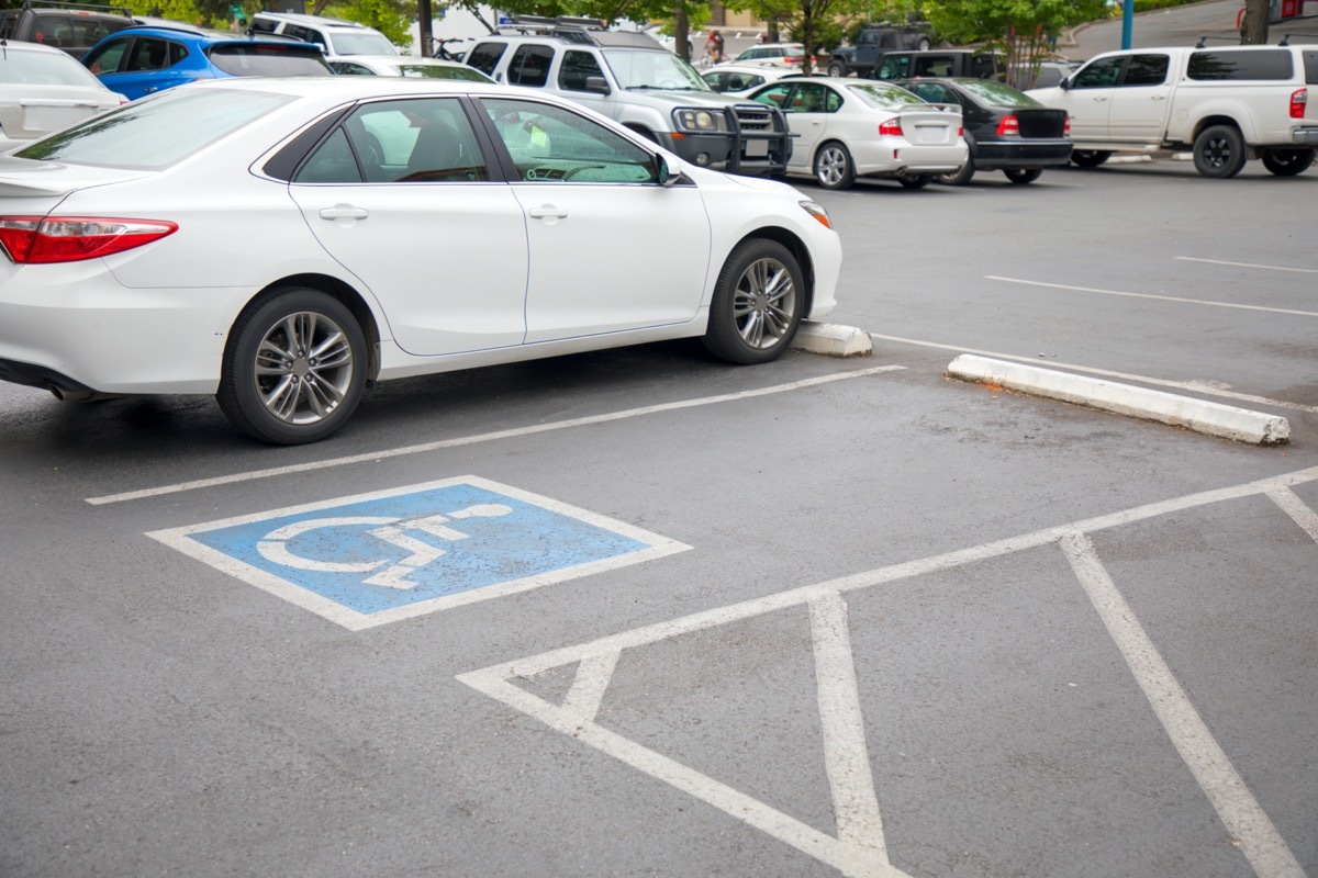 Handicapped parking spot in motel or apartment, transportation infrastructure road markings