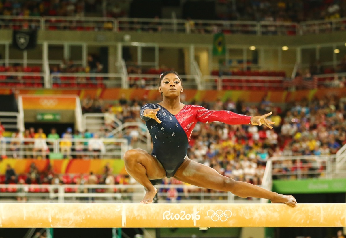 RIO DE JANEIRO, BRAZIL AUGUST 7, 2016: Olympic champion Simone Biles of United States competing on the balance beam at women's all-around gymnastics qualification at Rio 2016 Olympic Games - Image